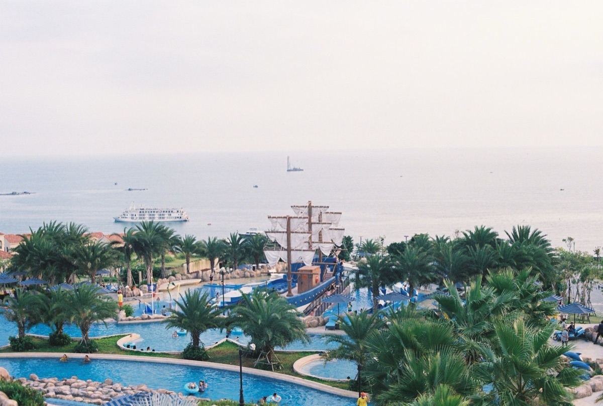 A vibrant family-friendly water park with colorful slides and shallow pools