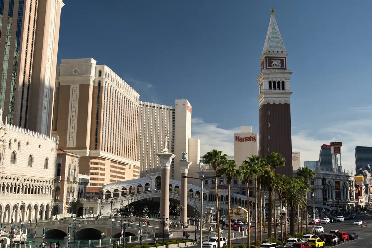 Daytime view of the Venetian Resort in Las Vegas featuring the iconic bell tower and bustling street scene.