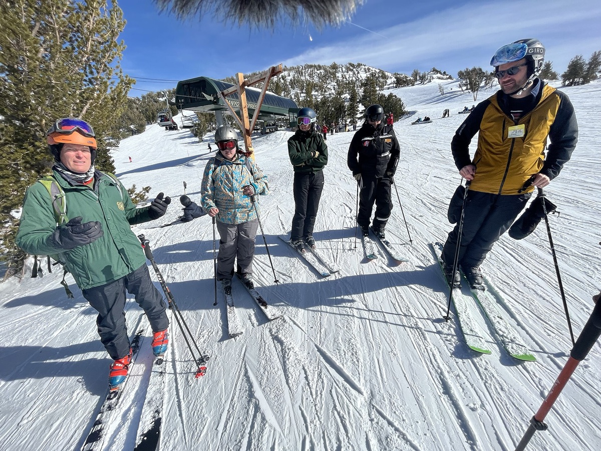 Ski resort with snow-covered trees and snowboarders