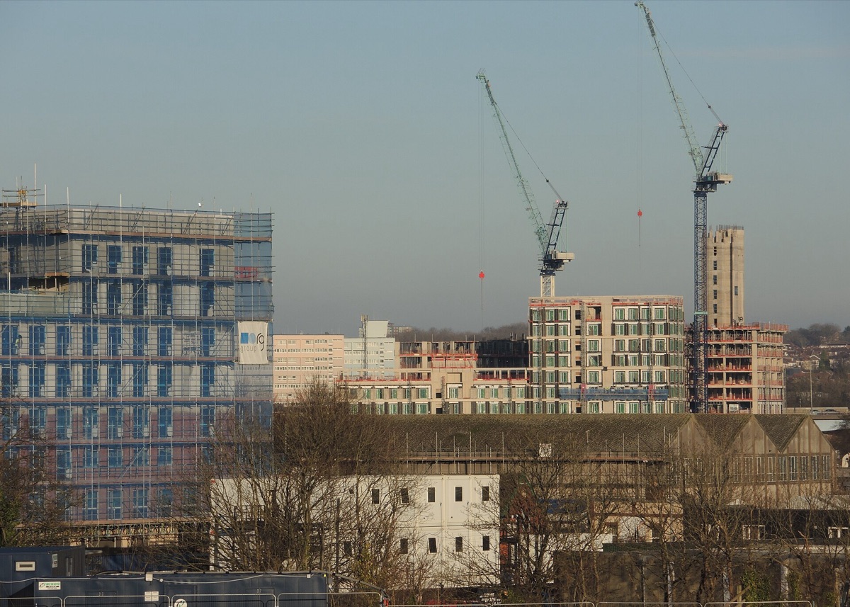 Luxury resort under construction with cranes and scaffolding