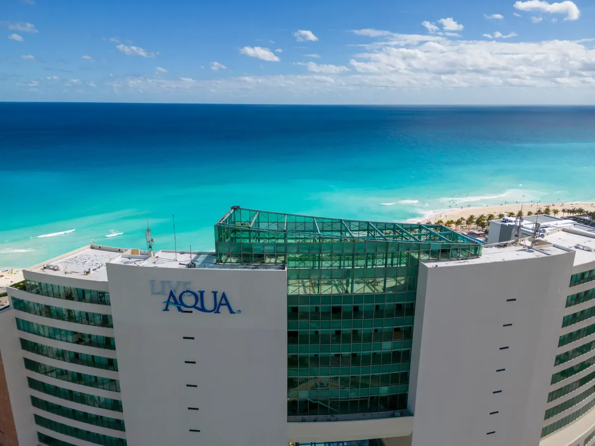 A stunning aerial view of Live Aqua Resort with turquoise sea in Cancun's hotel zone.